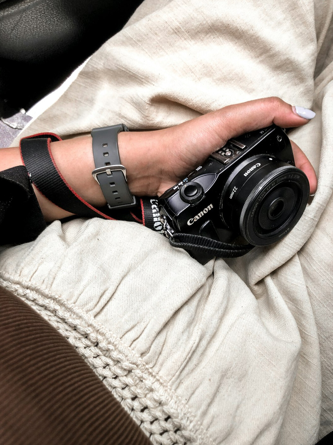 Photographer holding a professional camera backstage at an event