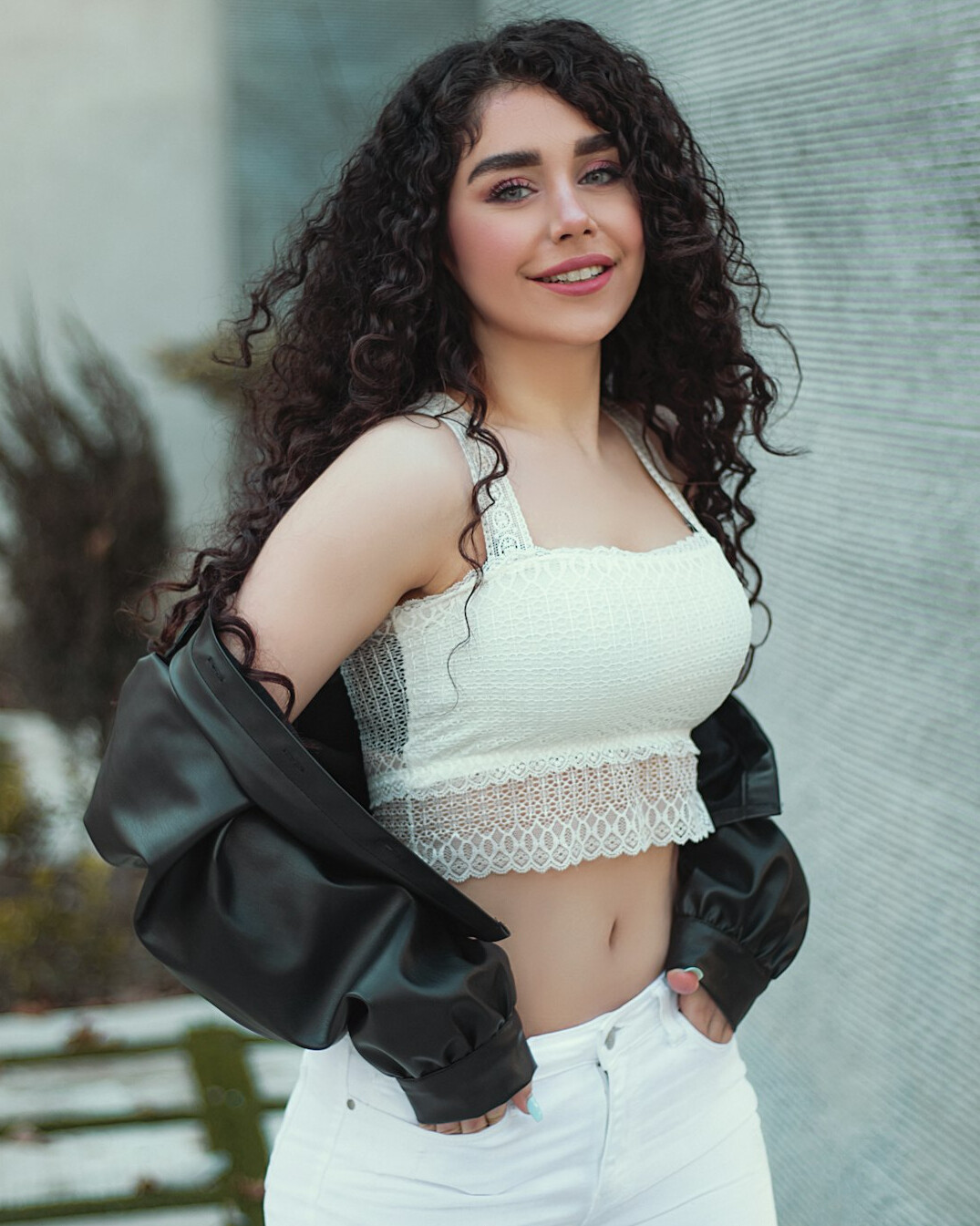 Portrait of a young Latina influencer with curly hair