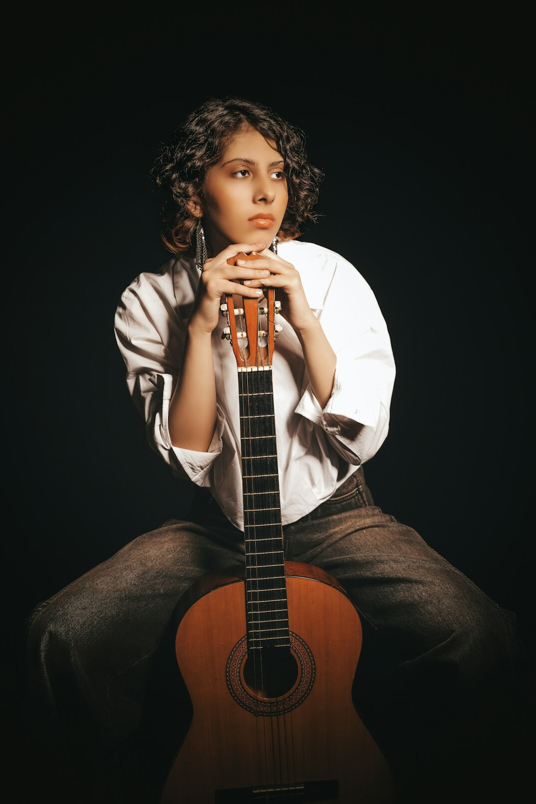 Portrait of a young Latino musician with a guitar